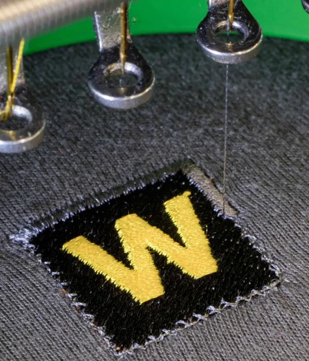 Industrial embroidery machine stitching company logo onto workwear — embroidery Woking